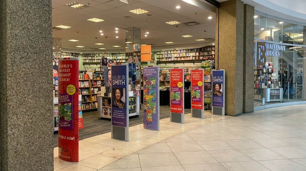 Exclusive Books promotional sleeves on Sensormatic anti-theft pedestals